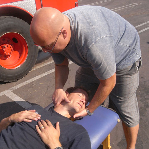 Dr. Klein adjusting firefighters neck