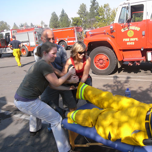 Dr. Klein, Roseanna, and Amanda all pulling the firefighters leg